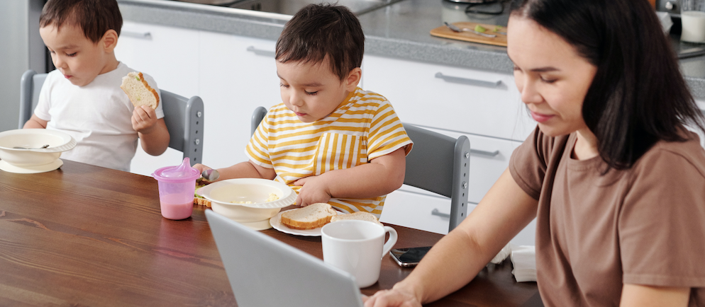 Mom working with twin sons